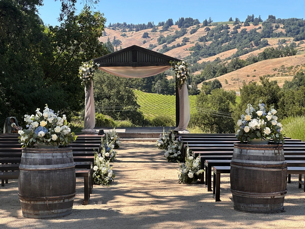 Wedding ceremony site with arbor and vineyards