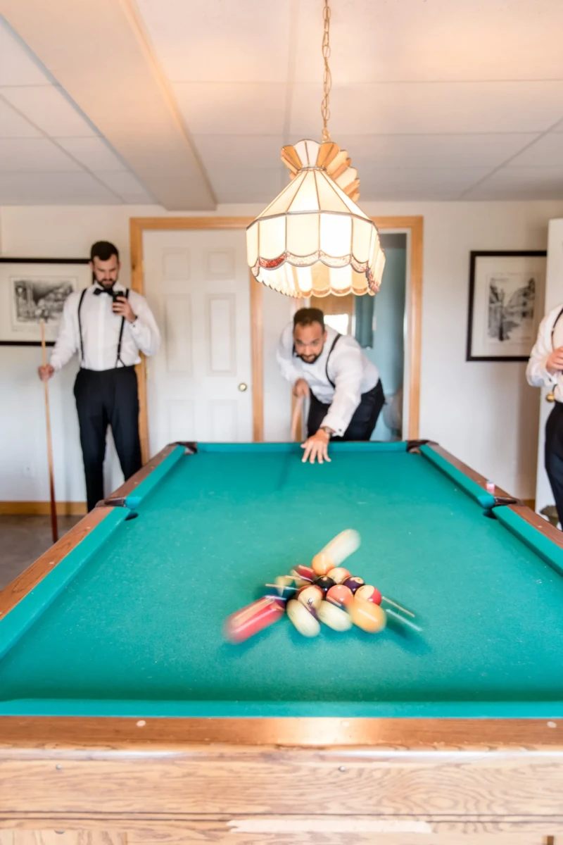 Groomsmen having fun in the Billiard Room of the Estate