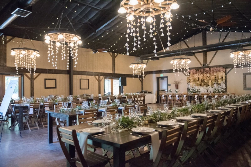 Chandeliers and draping inside modern barn