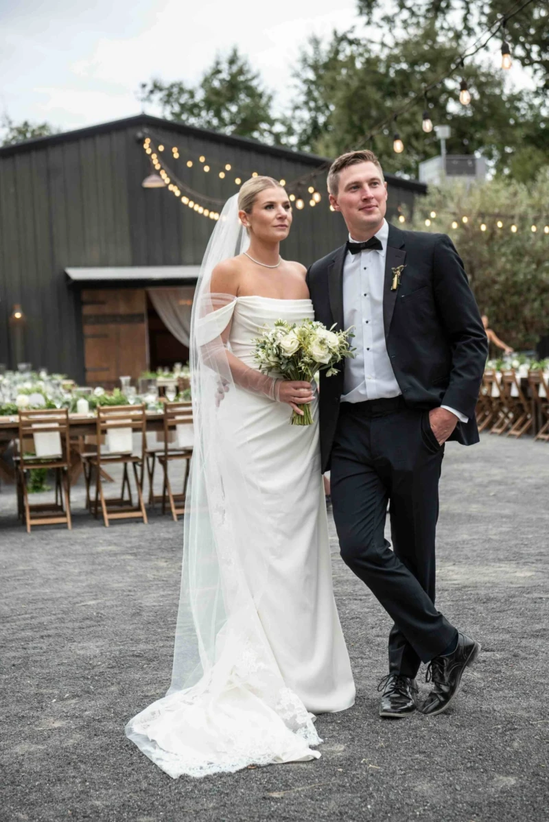 Groom and Bride Posting Outside Four Seasons Barn