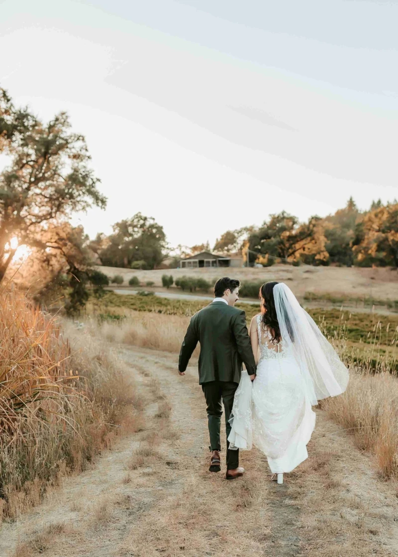Groom and Bride walking near fields